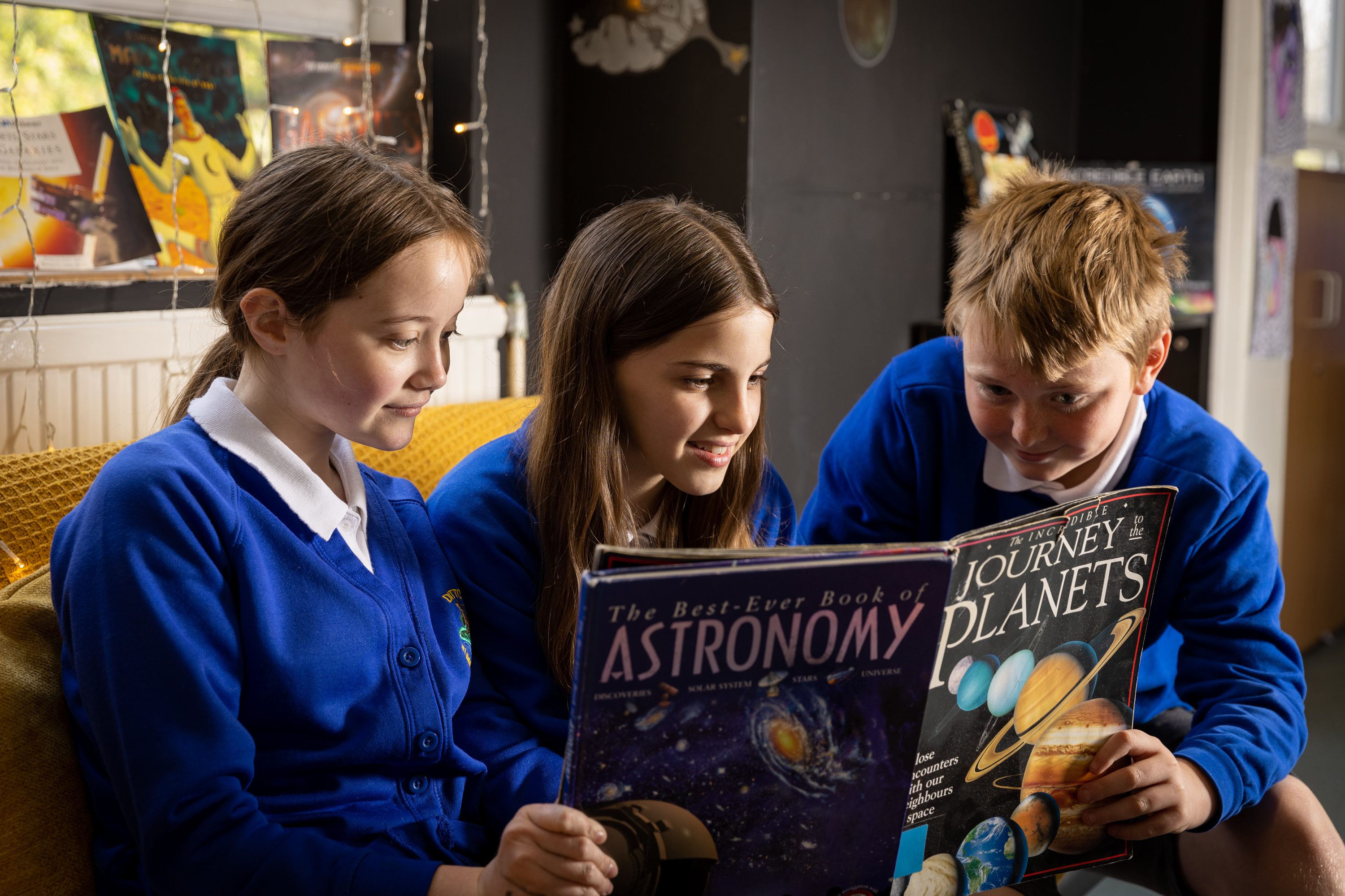 Ditton Junior Sch 27.04.23-15 three pupils reading a book on astronomy
